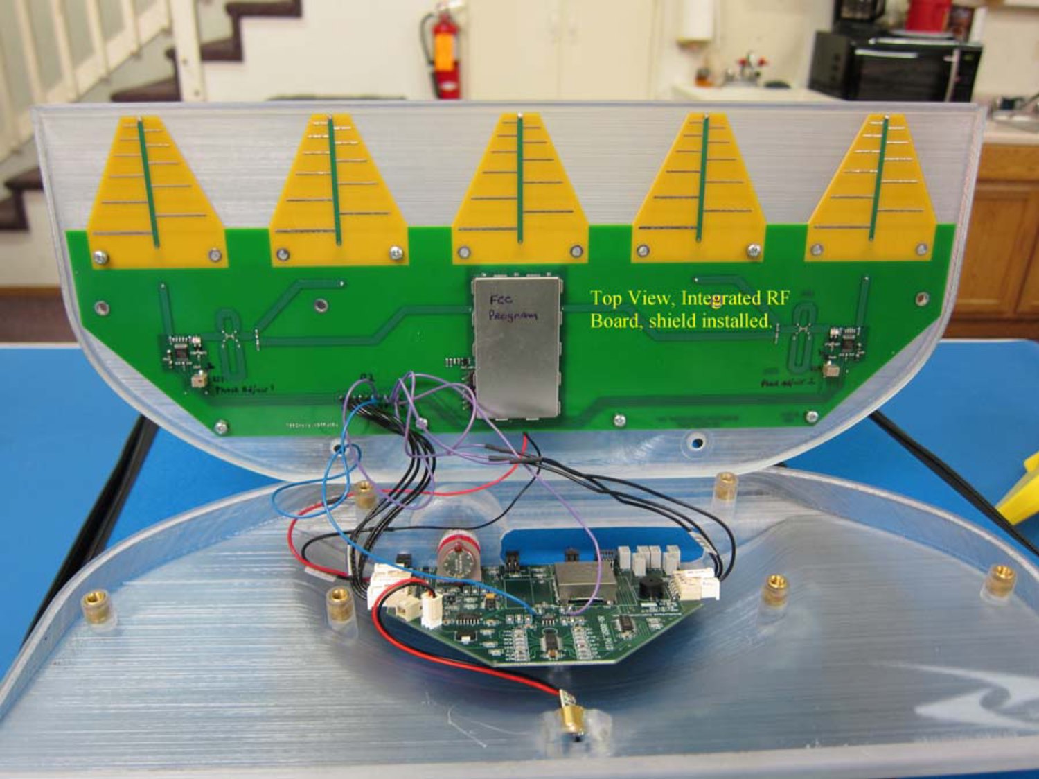 Photograph from SubSurface Instruments' own 2012 FCC filing showing the AML opened up: five yellow Yagi antennas on a green integrated RF board, with the shield installed.