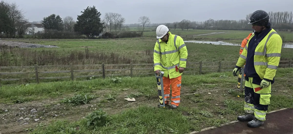 Trainee scanning for underground utilities with a CAT4 locator